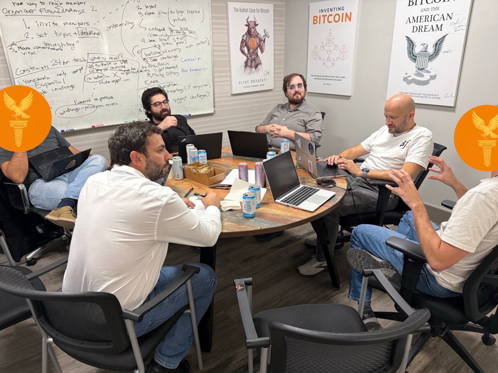 The team in deep discussion around a conference table at Bitcoin Park, planning the Pathos architecture