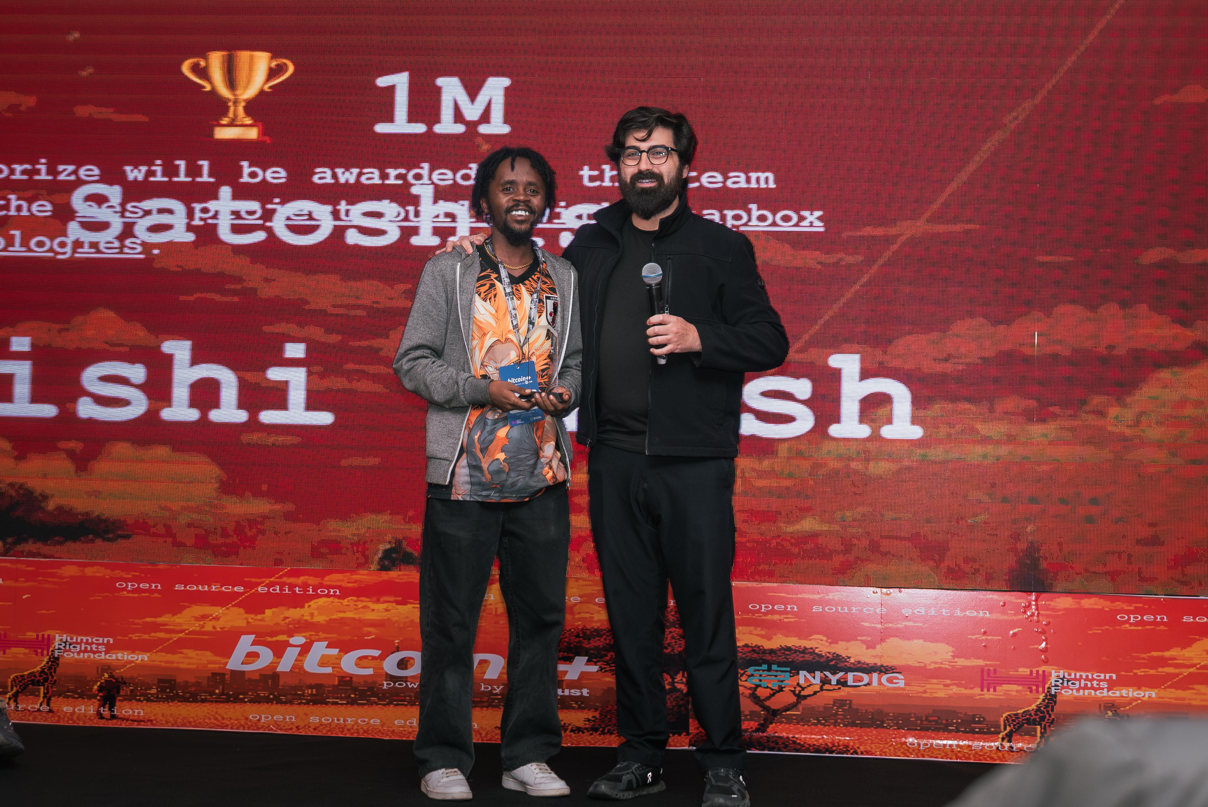 Alex Gleason awards a hackathon prize at BTC++ Nairobi, June 2026